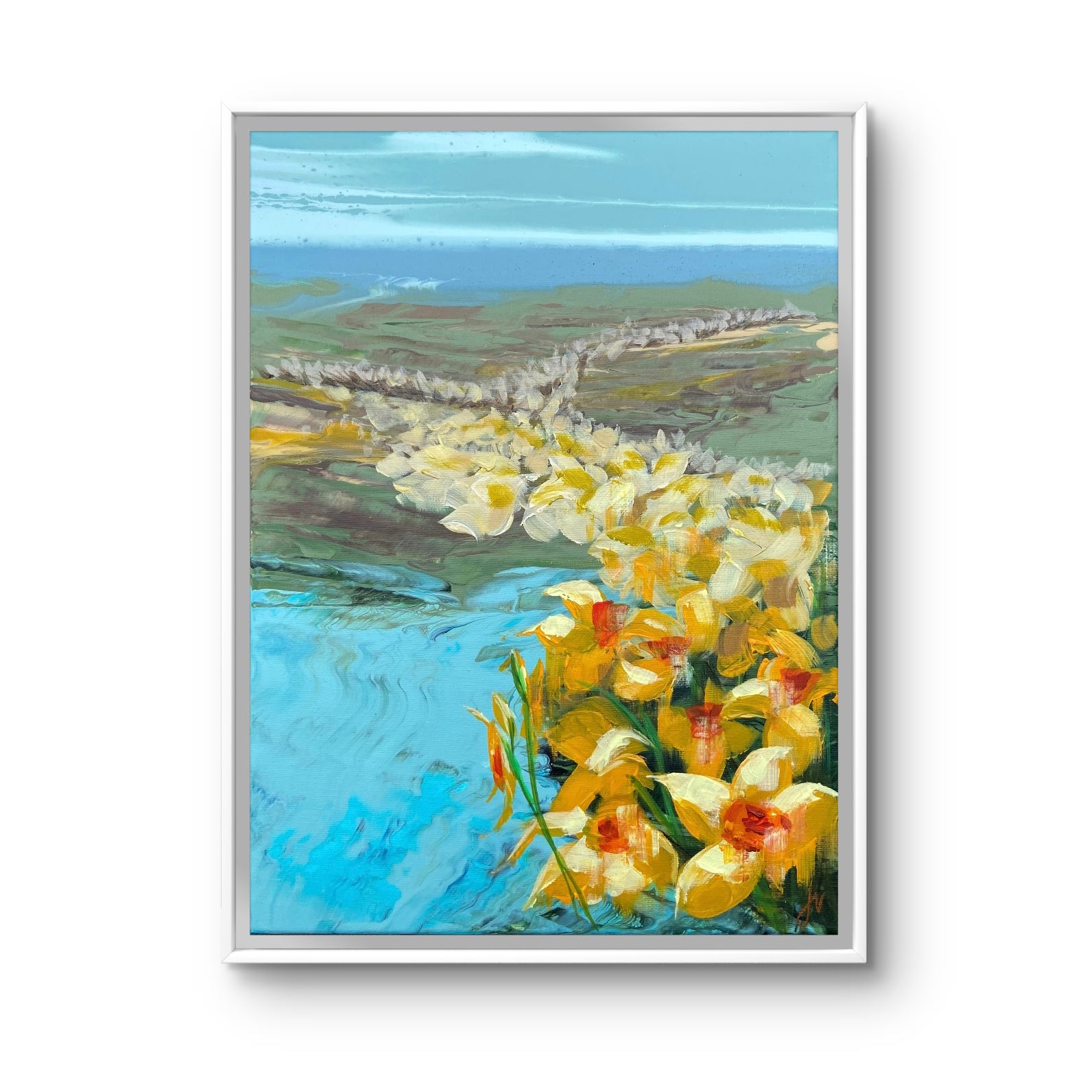 Framed painting of yellow flowers by a body of water with a landscape in the background.