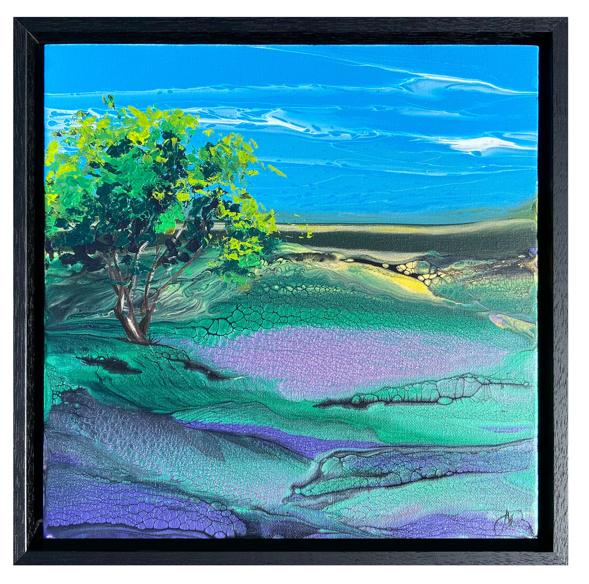 Framed artwork of a landscape with a tree on a hillside under a blue sky.